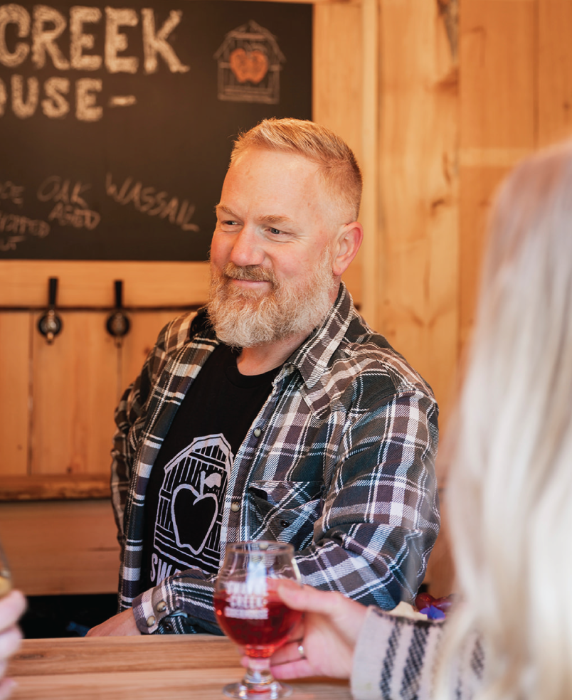Andrew Hain Cider Maker talking to guest at the bar 